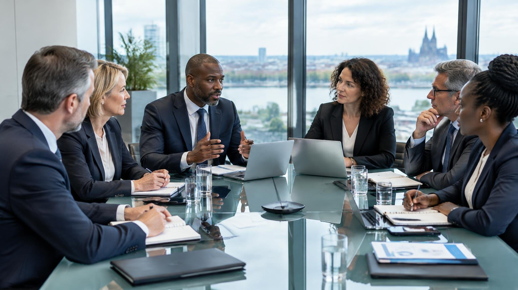 Executives seated around a boardroom table discussing operations strategy